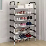 Multi-tiered shoe rack with various shoes on a plain background